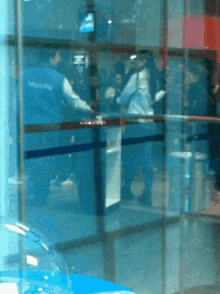 a man in a blue vest that says ' allianz ' on it