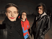 a group of young men are posing for a picture and one of them has red lipstick on his lips