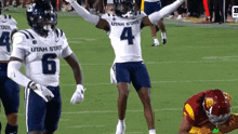 a football player with utah state on his shirt