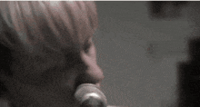 a woman is singing into a microphone in a black and white photo .