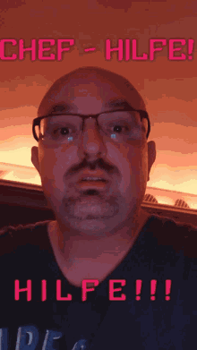 a bald man with glasses and a mustache is standing in front of a sign that says chef hilfe !!!