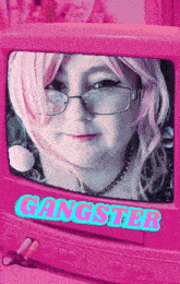 a woman with pink hair and glasses is displayed on a pink screen with the word gangster written on it