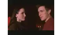 a man and a woman are looking into each other 's eyes .