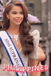 a woman with a sash that says miss supranaty philippines