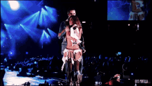 a man and a woman on a stage with the words gifs portalan on the bottom left