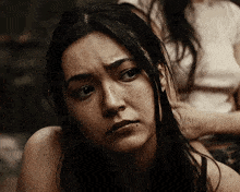 a close up of a woman 's face with a tear running down her face .