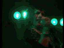 a man is singing into a microphone in a dark room .