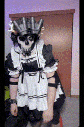 a person dressed as a maid with a skull mask on