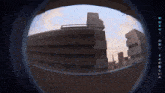 a view of a building through a fisheye lens with chinese writing on the bottom