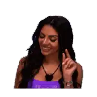 a woman in a purple tank top is smiling and pointing her finger