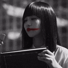 a black and white photo of a girl with red lipstick on her face