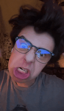 a man wearing glasses is making a funny face with his mouth open