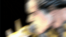a blurred image of a person playing a saxophone