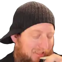 a man with a beard is wearing a black hat and drinking from a bottle