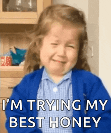 a little girl in a blue sweater is crying and saying i 'm trying my best honey