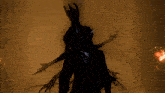 a silhouette of a monster with horns and clawed hands