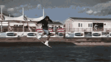 a man is jumping in the air while riding a wakeboard