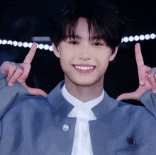 a young man with braces on his teeth makes a peace sign with his hands