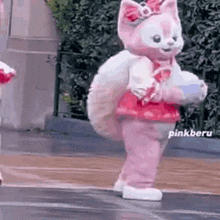 a stuffed animal dressed as a cat is standing on a wet floor .