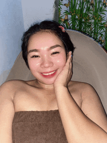 a woman laying in a bathtub with her hand on her face