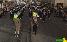 a group of people marching down a street with a sign that says ea