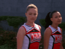 two cheerleaders wearing red white and black uniforms that say glee