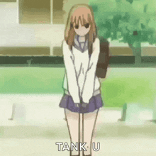 a girl in a school uniform is standing in front of a green field and says tank u