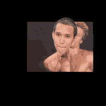 a man with a shaved head looks at the camera