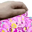 a close up of a cartoon drawing of a pink rabbit with a bow .