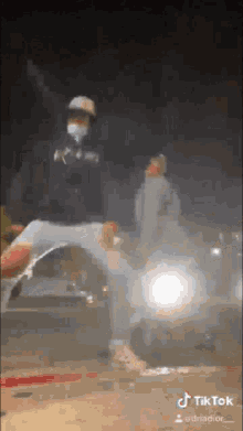 a man wearing a mask is kicking a car in a tiktok video ..