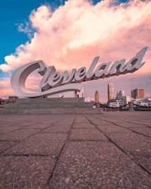 a large sign that says cleveland in front of a city