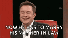 elon musk is smiling while sitting in a red chair and saying `` now he has to marry his mother-in-law ''