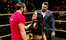 a man and a woman are wrestling in a ring .