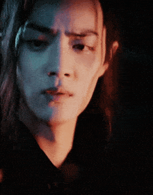a close up of a woman 's face with a serious expression