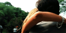 a man is carrying a woman on his back while riding a roller coaster .