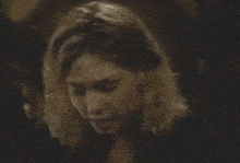 a blurry picture of a woman holding a glass of wine