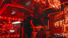 a movie poster for tron ares shows a man in a black suit