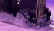 a purple background with a black object in the middle of it