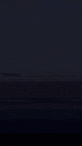 a purple light is coming out of the center of a dark room .