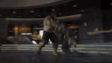 a hulk is breaking through a wall in a building