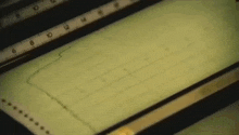 a graph is displayed on a screen with a ruler behind it