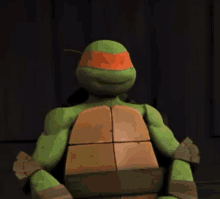 a turtle from the teenage mutant ninja turtles is sitting in a chair .