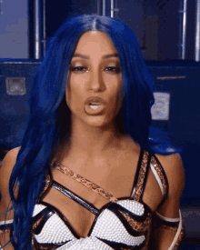 a woman with blue hair is wearing a leopard print outfit