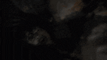 a blurred image of a person 's face with a hand on it