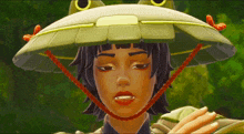 a girl wearing a frog hat with a red string around her neck