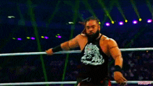 a man in a wrestling ring with the word wrestling on the bottom left