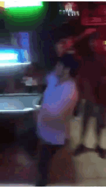 a blurry picture of a person walking in front of a green light