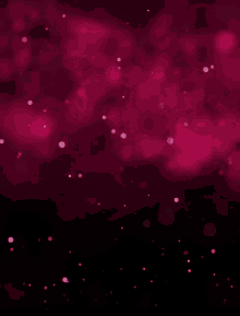 a blurred image of pink dots on a black background .