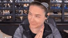 a woman wearing a headband and hoop earrings looks at the camera