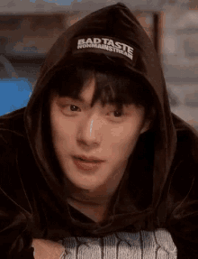 a close up of a person wearing a hoodie with a hat on .